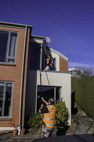 Window cleaning: different methods used to access different parts of the house.